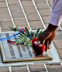 Placing Apple for Christa McCauliffe at Astronaut Memorial