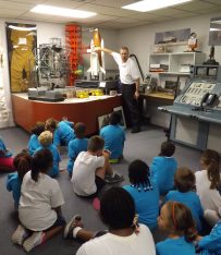 Docent Bruce Jacobs teaching kids in American Space Museum Space Shuttle Gallery
